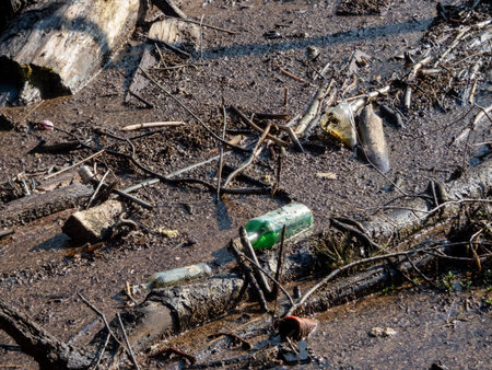 River pollution. Floating garbage in the water. Plastic bottles floating in the water with dirt.