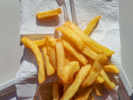 Golden and crispy french fries on white napkin. Fast food snackの写真素材