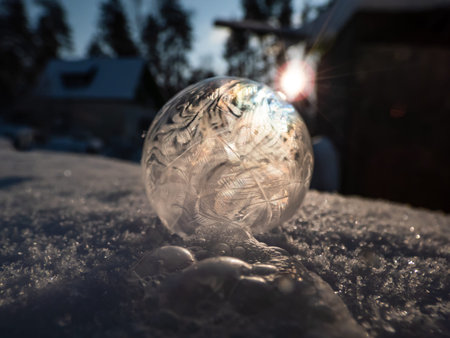 Macro shot of round, frozen soap bubble forming beautiful leaf and tree like pattern while freezing...