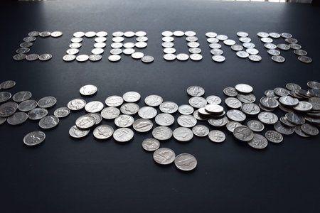 A pile of american coins with corona written by coins in isolated black background.