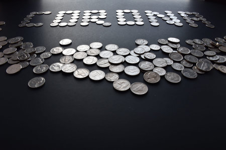 A pile of american coins with corona written by coins in isolated black background.