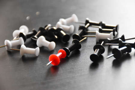 colorful punch pins drawing pins on black background, office supply, notes, school supply, notice board pins, colors, individuality, uniqueness, leadership, be differentの写真素材