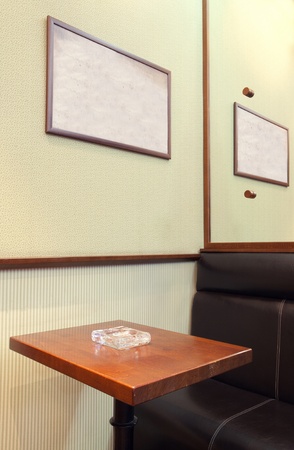 Details of an interior of a small cafe. Just chairs, empty frames and tables.の写真素材