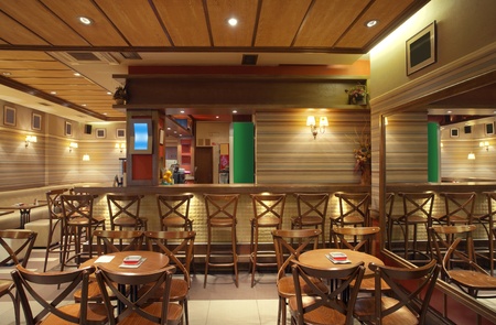Cafe interior with wooden furniture, lighting equipment and decoration.の写真素材
