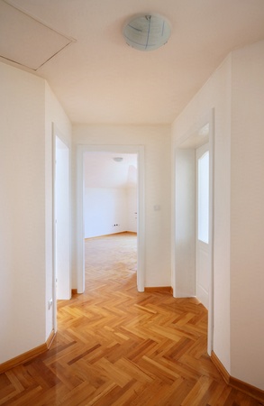 Interior of a new home, empty room with white walls and parquet. の写真素材