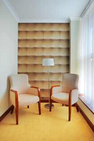 Interior of a hotel room, two armchairs and a lamp, beside the window. の写真素材