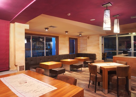 Interior of a modern restaurant, classical design, by night. の写真素材