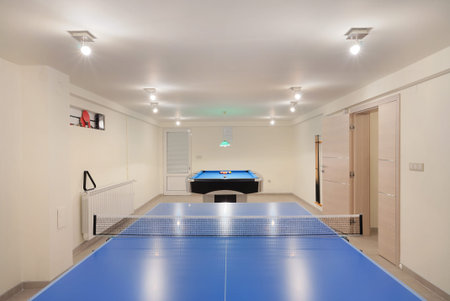 Interior of an entertainment room, billiard and tenis table details. 