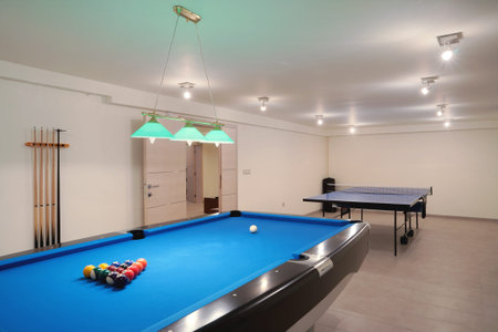 Interior of an entertainment room, billiard and tenis table details. 