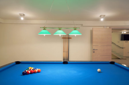 Interior of an entertainment room, billiard and tenis table details. 