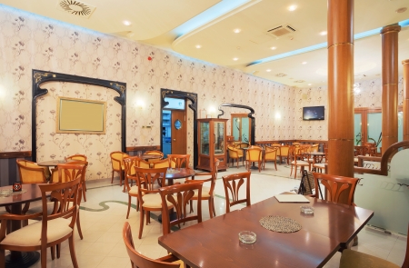 Interior of a restaurant, vintage style, wooden classical furniture, retro wallpapers, during night. の写真素材