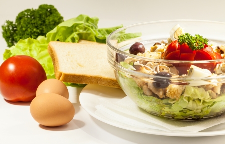 Healthy meal, chicken salad in glass pot and various vegetables  の写真素材