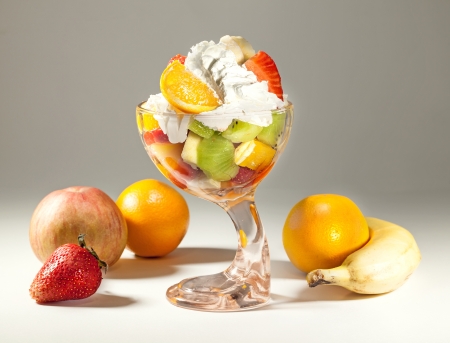 Glass dish full of various fruits, studio isolated  の写真素材