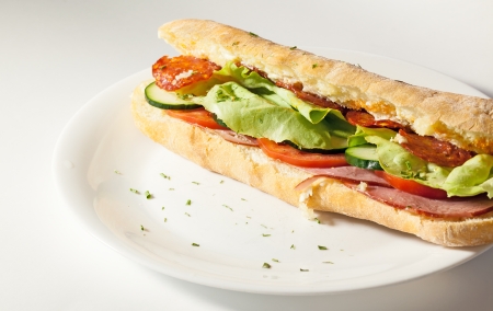 Sandwich with lettuce and tomato salad and hum, studio isolated on white plate  の写真素材