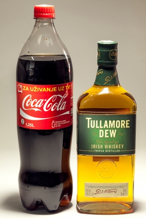 Cacak, Serbia - May 20, 2013: Coca Cola and Tullamore DEW Whiskey, studio isolated. のeditorial素材