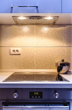 Part of a modern kitchen, electric stove details with aspirator.の写真素材