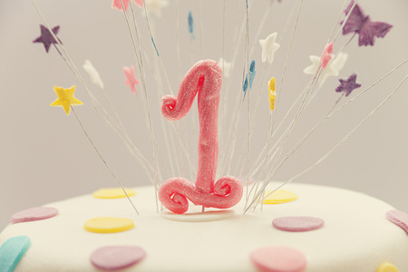 Cake for first birthday, number one made of sugar on top with stars around it  の写真素材