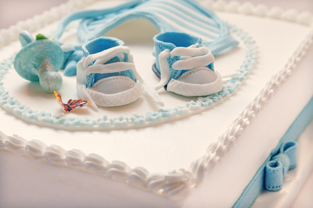 Birthday cake for baby, blue and white design, on light gray の写真素材
