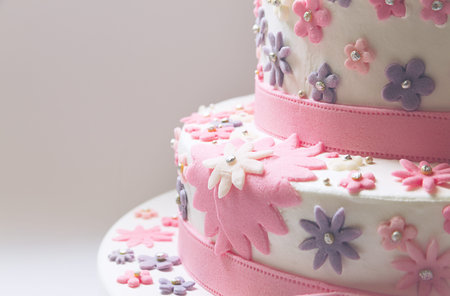 Details of a birthday cake, decorative stars in pink made of sugar 