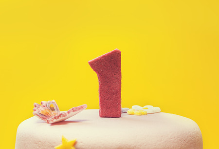 Decoration of a birthday cake with number one made of sugar on top  の写真素材