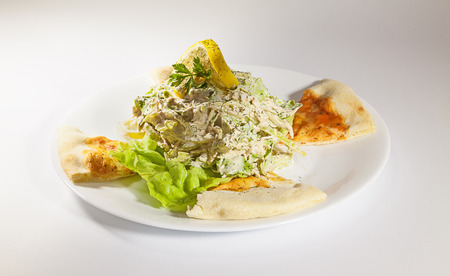 Bread and vegetable salad on white plate.の写真素材