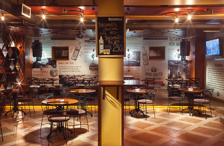 Cacak, Serbia - January 23, 2015: Velvet Cafe and Club interior, modern design with vintage chairs and tables and illustrative wallpapers.のeditorial素材