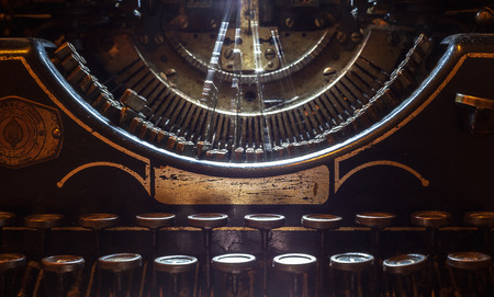 Details of an old typewriting machine, retro style with dusty metal and buttons.の写真素材