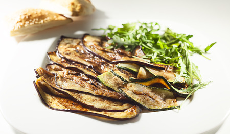 Details of grilled eggplant, served on white plate.の写真素材