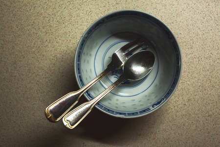 Details of a Chinese dish, with spoon and fork in it.の写真素材