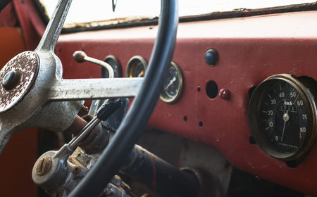 Old bus interior, view on steering wheel and control table.