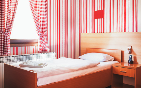 Hotel room interior, calm and peaceful atmosphere in red and white.の写真素材
