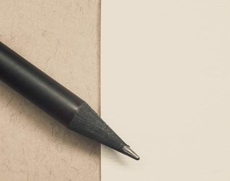 Black new wooden pencil and white paper simple composition with empty space.の写真素材