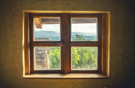 Interior details of an old retro house, window closeup with view on countryside.