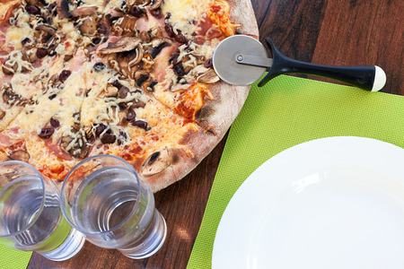 Lunch time, Greek Pizza on table and accessories.の写真素材