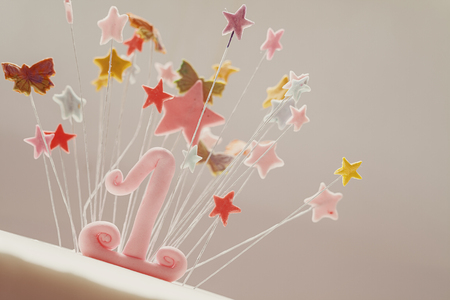Birthday cake decoration, number one and stars made of sugar.の写真素材