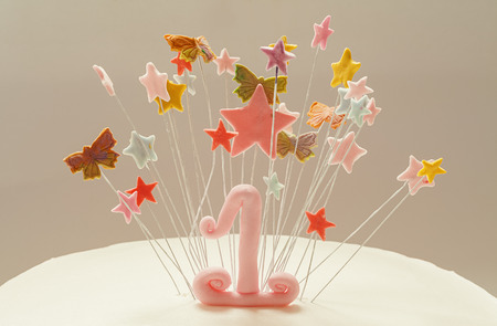 Birthday cake decoration, number one and stars made of sugar.の写真素材