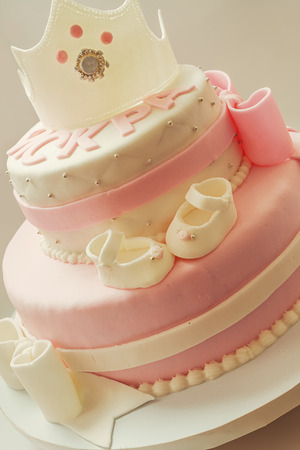 Decoration details of a birthday cake made for little baby girl, in pink and white.の写真素材
