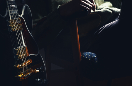 Black electric guitar, 335 model and a part of its owner.の写真素材