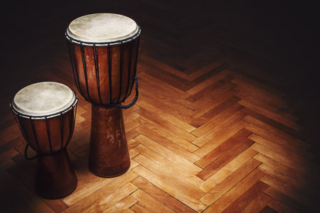 Two old vintage style wooden djembes, percussion instruments from Balkan and Africa.
