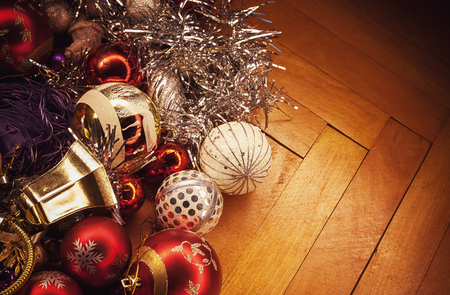 Old Christmas tree ornaments, colorful decoration prepared to be used, on parquet.の写真素材