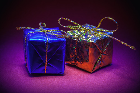 Details of Christmas tree decorated ornaments, partially illuminated.の写真素材