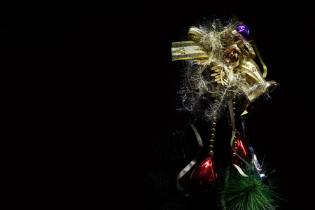 Details of Christmas tree decorated ornaments, partially illuminated.の写真素材