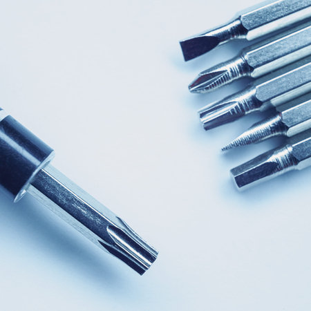 Various screwdriver heads, abstract composition with accent to differences and metal material, blue...