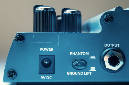 Details of a guitar pedal, part with power, phantom and output ports.
