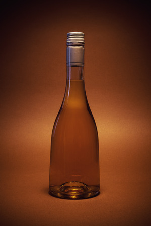 One bottle of spirit drink on brown background.の写真素材