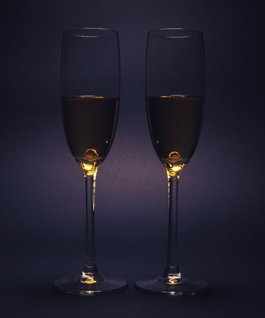 Luxury glasses with wine, studio isolated on purple background.の写真素材