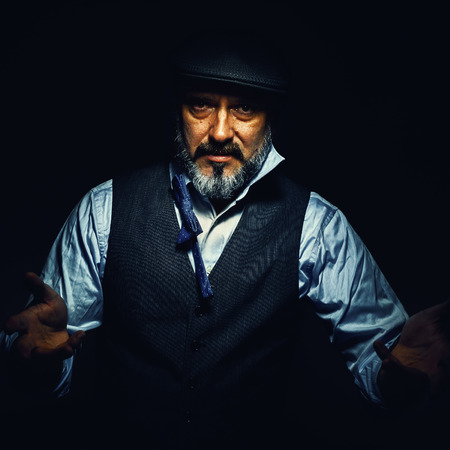 Portrait of an older man, explaining something. Vintage style of clothes.の写真素材
