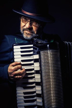 Portrait of an accordion player, playing and posing.の写真素材