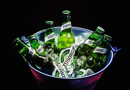 Cacak, Serbia - March 30, 2016: Six bottles of Tuborg beer in bucket, served for group of people.のeditorial素材
