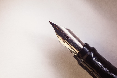 Closeup view of an old pen on white paper.の写真素材